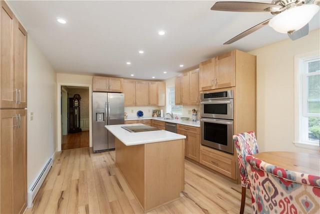 52 High St, Alfred, NY 14802 - kitchen featuring appliances with stainless steel finishes, a baseboard radiator, light brown cabinetry, a sink, and light wood-style floors