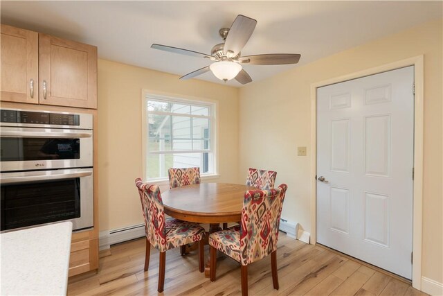 52 High St, Alfred, NY 14802 - dining area with light wood finished floors, a ceiling fan, a baseboard heating unit, and baseboards