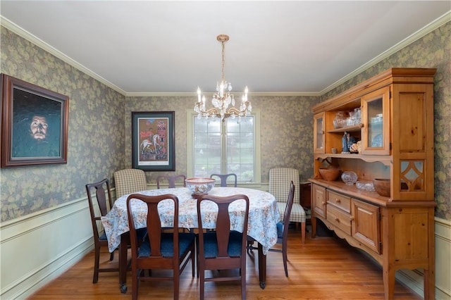 52 High St, Alfred, NY 14802 - dining space with a chandelier, light wood-style floors, wainscoting, wallpapered walls, and ornamental molding