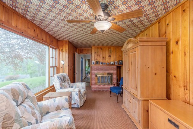 52 High St, Alfred, NY 14802 - living area with wooden walls, a fireplace, ceiling fan, and light colored carpet