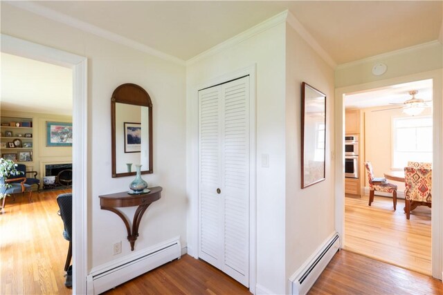 52 High St, Alfred, NY 14802 - hallway featuring a baseboard heating unit, wood finished floors, and crown molding