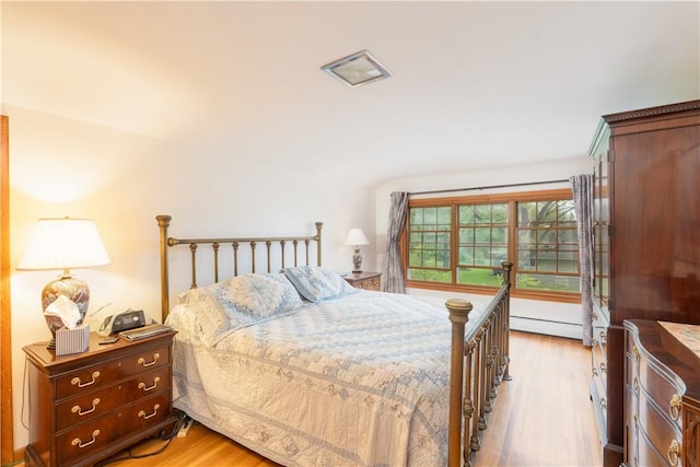 52 High St, Alfred, NY 14802 - bedroom featuring a baseboard heating unit and light wood-style floors