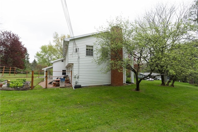 52 High St, Alfred, NY 14802 - view of side of property featuring a yard and a chimney