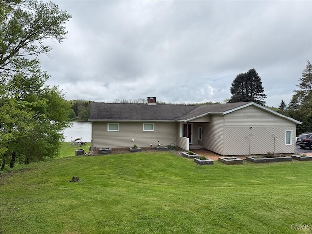 1404 Riverbend Dr, Lysander, NY 13027 - rear view of house featuring a chimney, a yard, and cooling unit