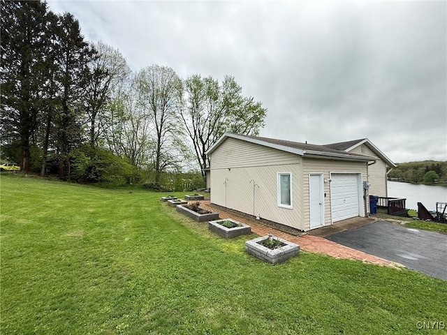 1404 Riverbend Dr, Lysander, NY 13027 - view of property exterior with driveway, a yard, a garden, and a garage
