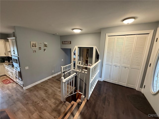 1404 Riverbend Dr, Lysander, NY 13027 - corridor featuring an upstairs landing, dark wood-style floors, and baseboards