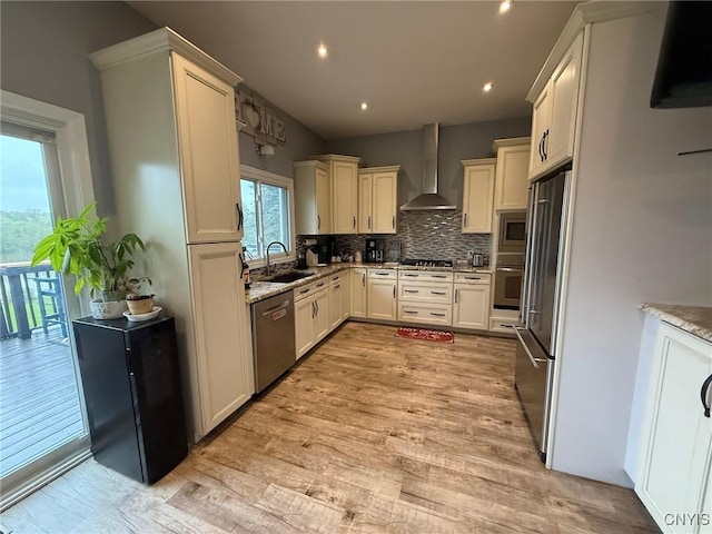 1404 Riverbend Dr, Lysander, NY 13027 - kitchen with appliances with stainless steel finishes, wall chimney exhaust hood, a sink, tasteful backsplash, and light stone countertops