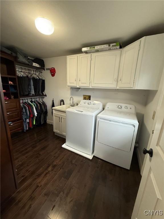 1404 Riverbend Dr, Lysander, NY 13027 - washroom featuring cabinet space, washing machine and dryer, dark wood-type flooring, and baseboards