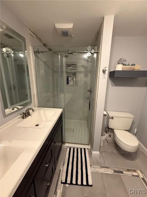 1404 Riverbend Dr, Lysander, NY 13027 - full bath featuring a stall shower, double vanity, toilet, and baseboards