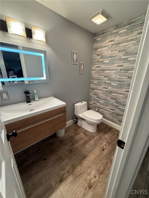 1404 Riverbend Dr, Lysander, NY 13027 - bathroom featuring toilet, vanity, wood finished floors, and baseboards