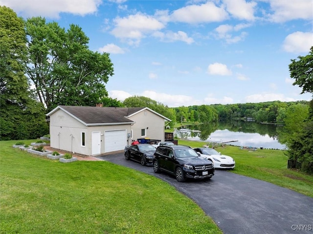 1404 Riverbend Dr, Lysander, NY 13027 - view of front of house featuring driveway, a water view, a front yard, and a garage