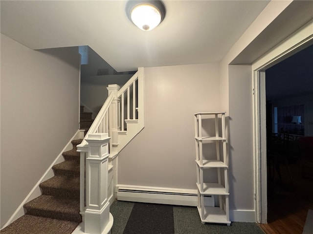 stairs featuring baseboards and a baseboard heating unit