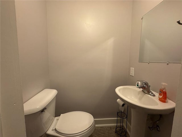 bathroom featuring toilet and baseboards