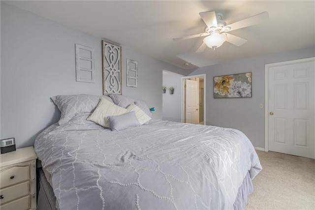 bedroom featuring light carpet, a ceiling fan, and baseboards