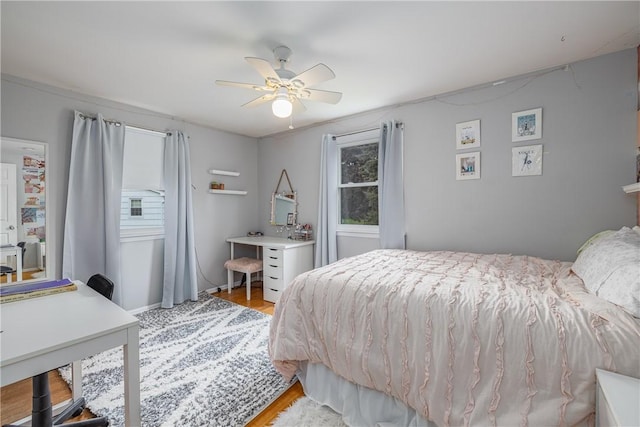 bedroom featuring light wood-type flooring and a ceiling fan
