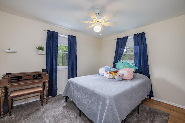 bedroom with baseboards, a ceiling fan, and wood finished floors