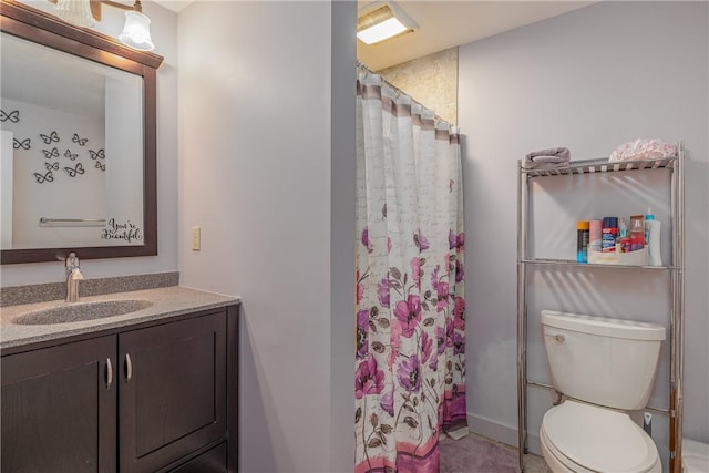 bathroom with vanity, toilet, and curtained shower