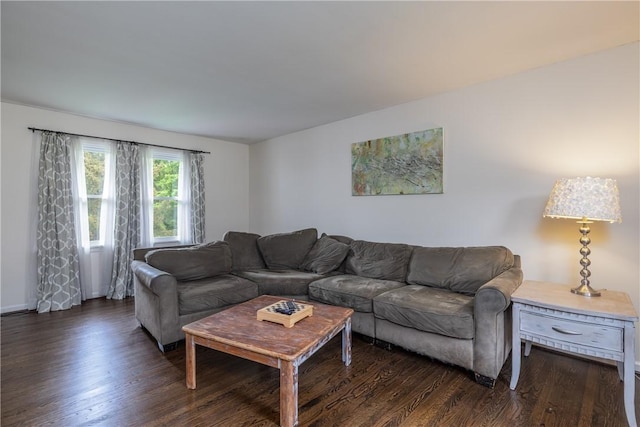 living room featuring dark wood-style flooring and baseboards