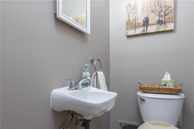 half bath with a sink and toilet