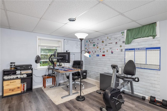 home office with a paneled ceiling, baseboards, and dark wood-style flooring