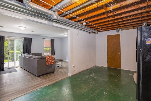 below grade area with freestanding refrigerator