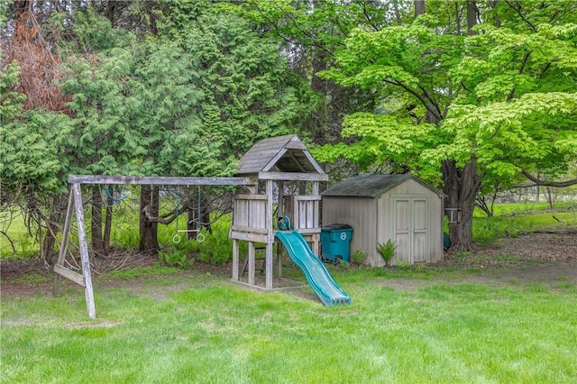 view of play area featuring a storage shed, a yard, and an outdoor structure