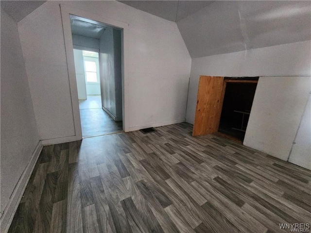 bonus room with wood finished floors and lofted ceiling