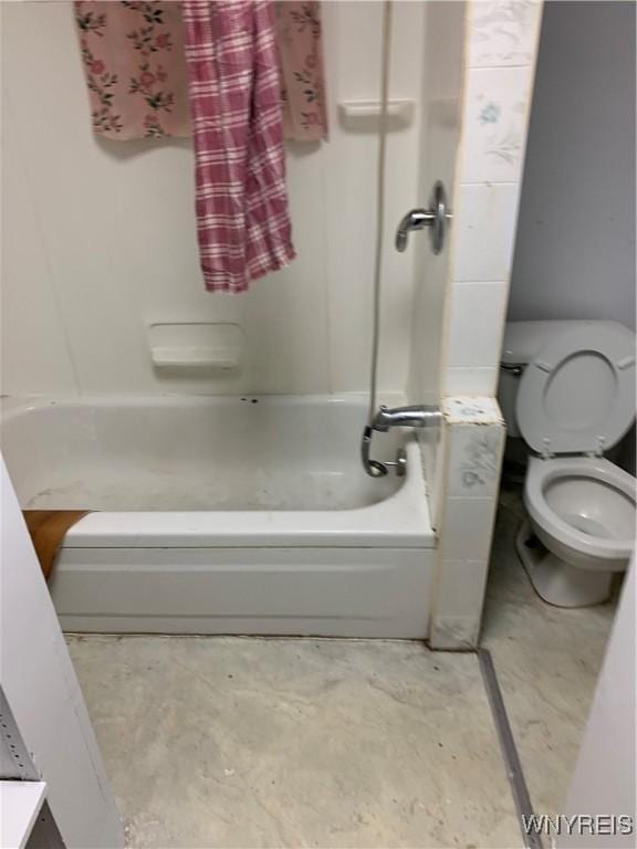 full bath with concrete flooring, toilet, and bathing tub / shower combination