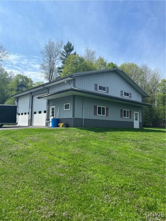 8054 Fargo Rd, Henderson, NY 13650 - view of home's exterior featuring a garage and a yard