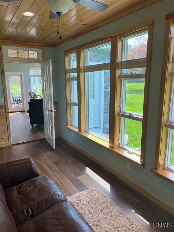 8054 Fargo Rd, Henderson, NY 13650 - living room featuring plenty of natural light, wooden ceiling, wood-type flooring, and baseboards