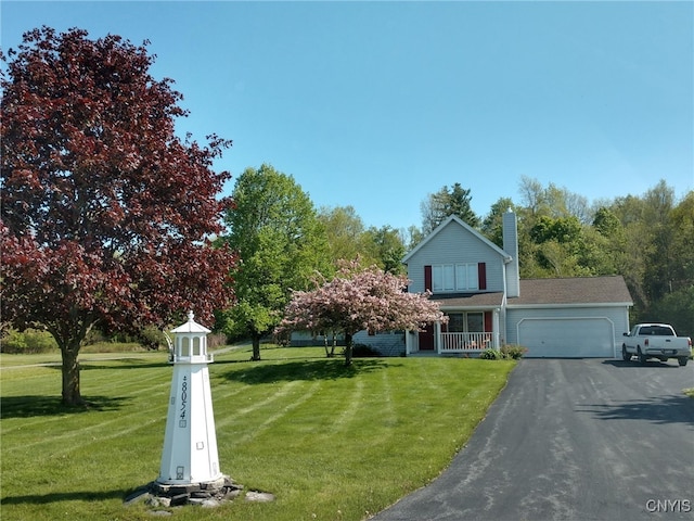 8054 Fargo Rd, Henderson, NY 13650 - view of front facade with an attached garage, a chimney, driveway, and a front lawn