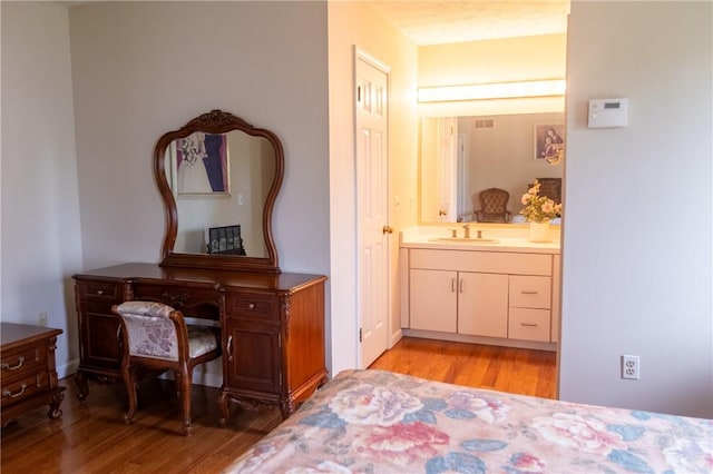 401 Montvale Ln, Greece, NY 14626 - bedroom featuring a sink, light wood-style floors, and connected bathroom