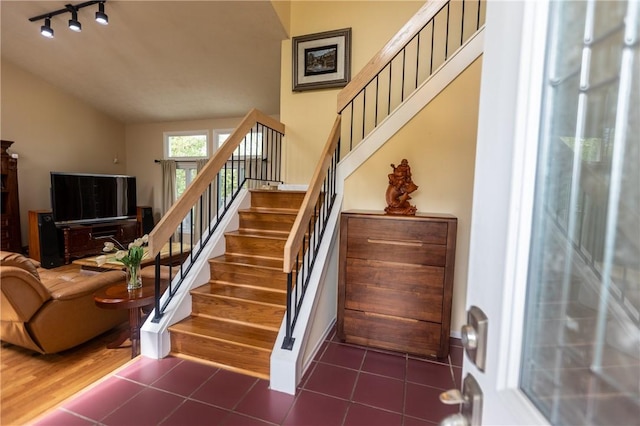 401 Montvale Ln, Greece, NY 14626 - stairs with vaulted ceiling, track lighting, and tile patterned flooring