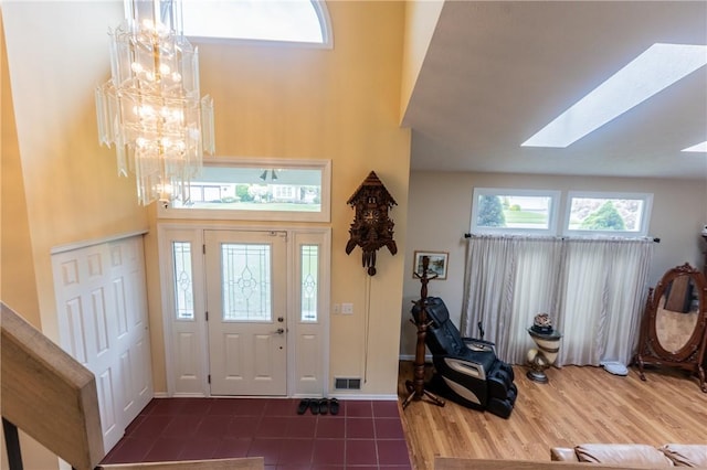 401 Montvale Ln, Greece, NY 14626 - tiled entrance foyer featuring a towering ceiling, a chandelier, a skylight, and baseboards