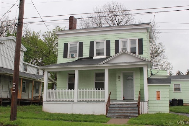 view of front of property with covered porch, a chimney, cooling unit, and roof with shingles