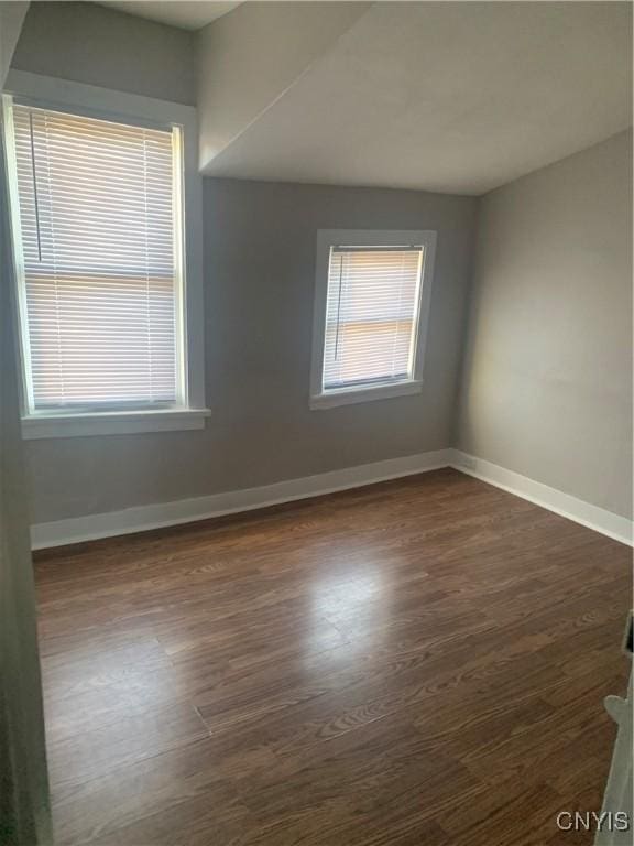 empty room with wood finished floors and baseboards