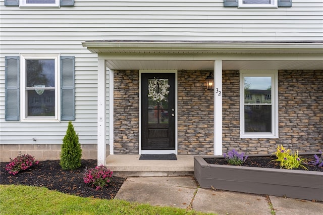 doorway to property featuring covered porch