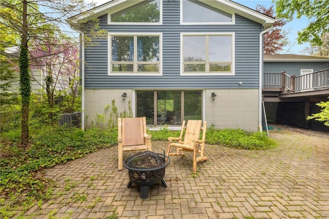 back of house featuring a fire pit, a patio, and central air condition unit
