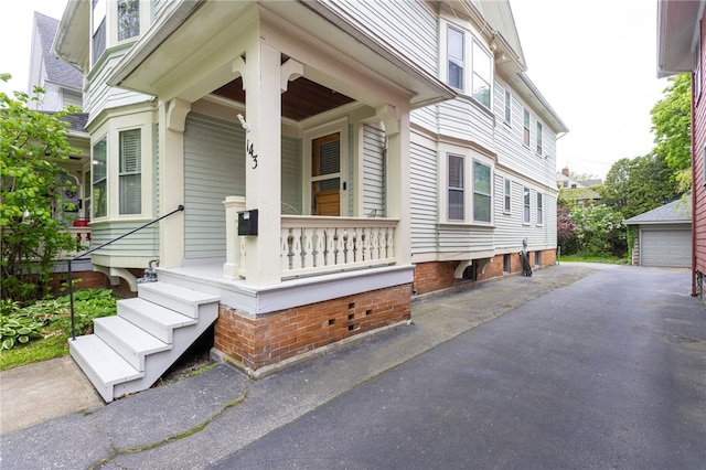 view of exterior entry with a porch