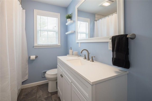 full bathroom featuring baseboards, toilet, and vanity