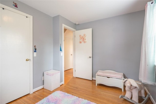 bedroom with wood finished floors and baseboards