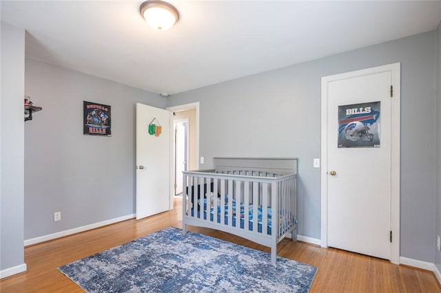 bedroom with baseboards and wood finished floors