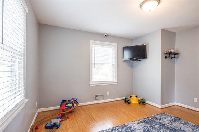 playroom with wood finished floors and baseboards