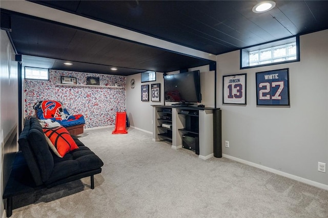 sitting room featuring carpet floors, plenty of natural light, and baseboards