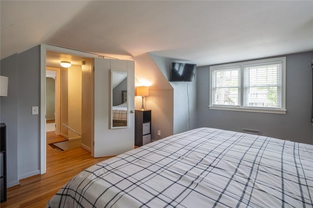 bedroom featuring wood finished floors and baseboards