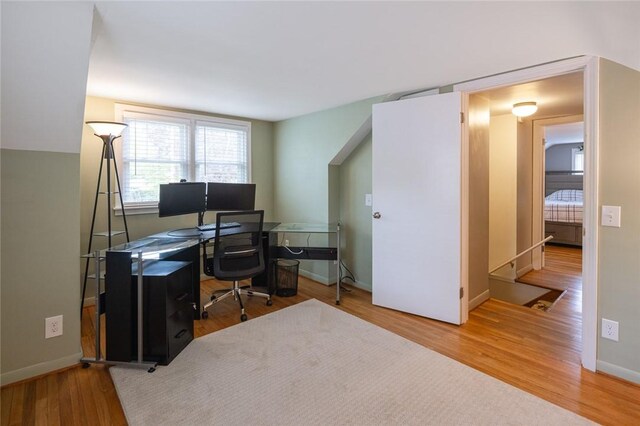 home office with wood finished floors and baseboards