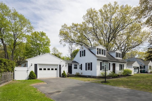 cape cod-style house featuring asphalt driveway and a garage