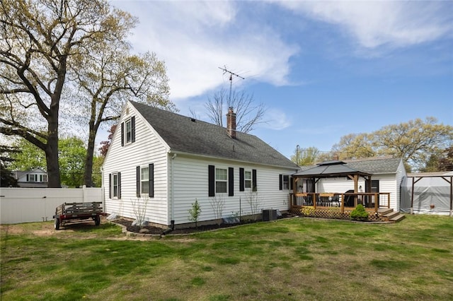 back of property featuring a gazebo, a chimney, roof with shingles, and cooling unit