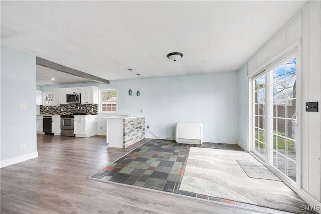 1019 State Route 49, Constantia, NY 13028 - kitchen featuring appliances with stainless steel finishes, open floor plan, white cabinetry, and wood finished floors