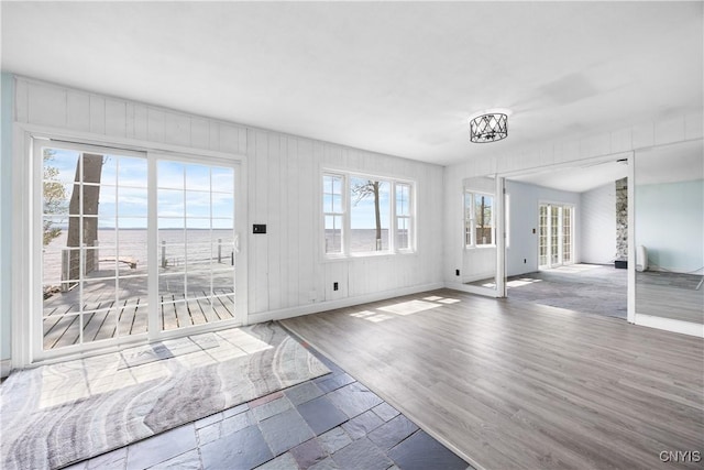 1019 State Route 49, Constantia, NY 13028 - unfurnished living room featuring baseboards, a chandelier, and wood finished floors